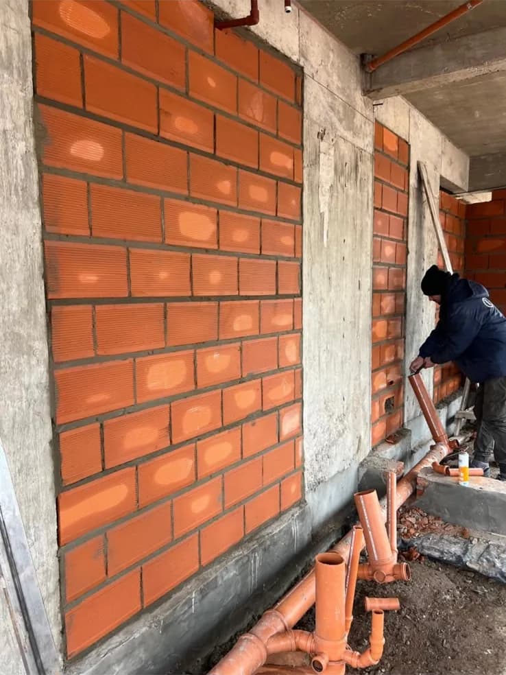 Avance de obra de La Florida — muro de ladrillo visto y tendido sanitario